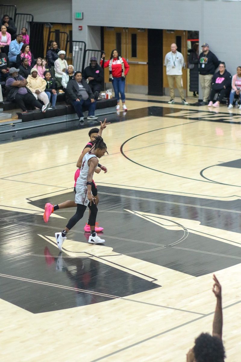 Dillon Wright, Junior, celebrates at mid court after hitting a 3 pointer.