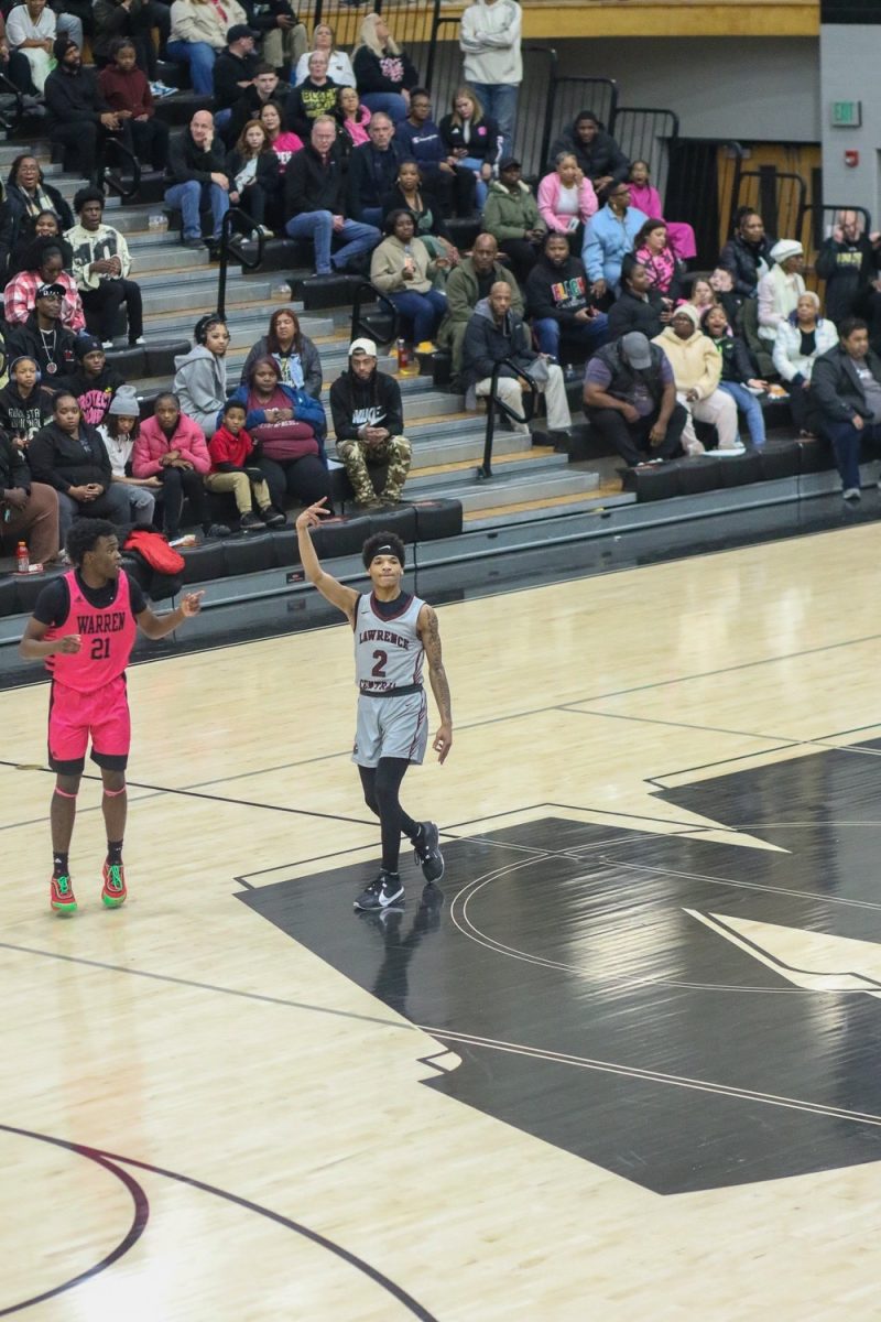 Doron Harris, Junior, celebrates towards his bench after drilling a 3 pointer.