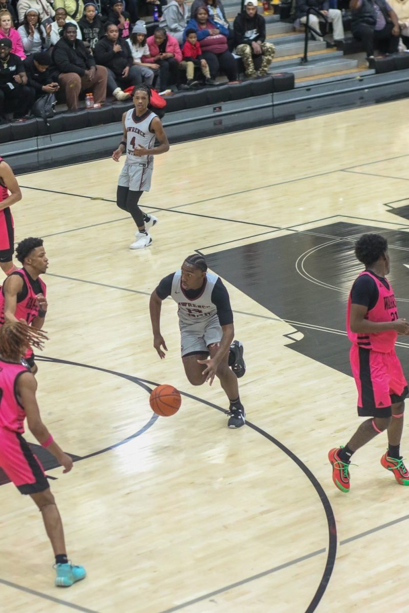 Albert Gooden III, Junior, dribbles the ball past Warren Central defenders.