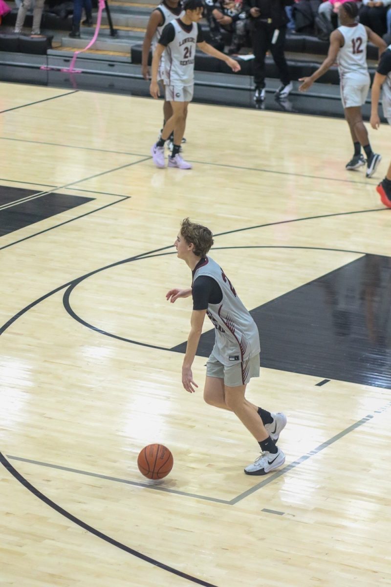 Ty Ferguson, Sophomore, dribbles the ball during warmups.