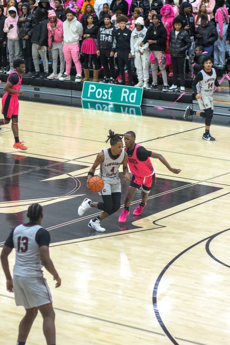 Dillon Wright, Junior, dribbles past a Warren Central defender towards the rim.