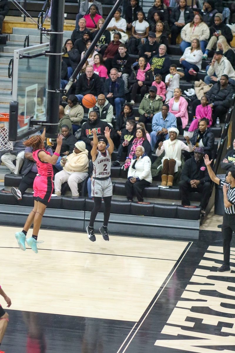 Doron Harris, Junior, shoots a 3 pointer in the 1st half vs Warren Central.