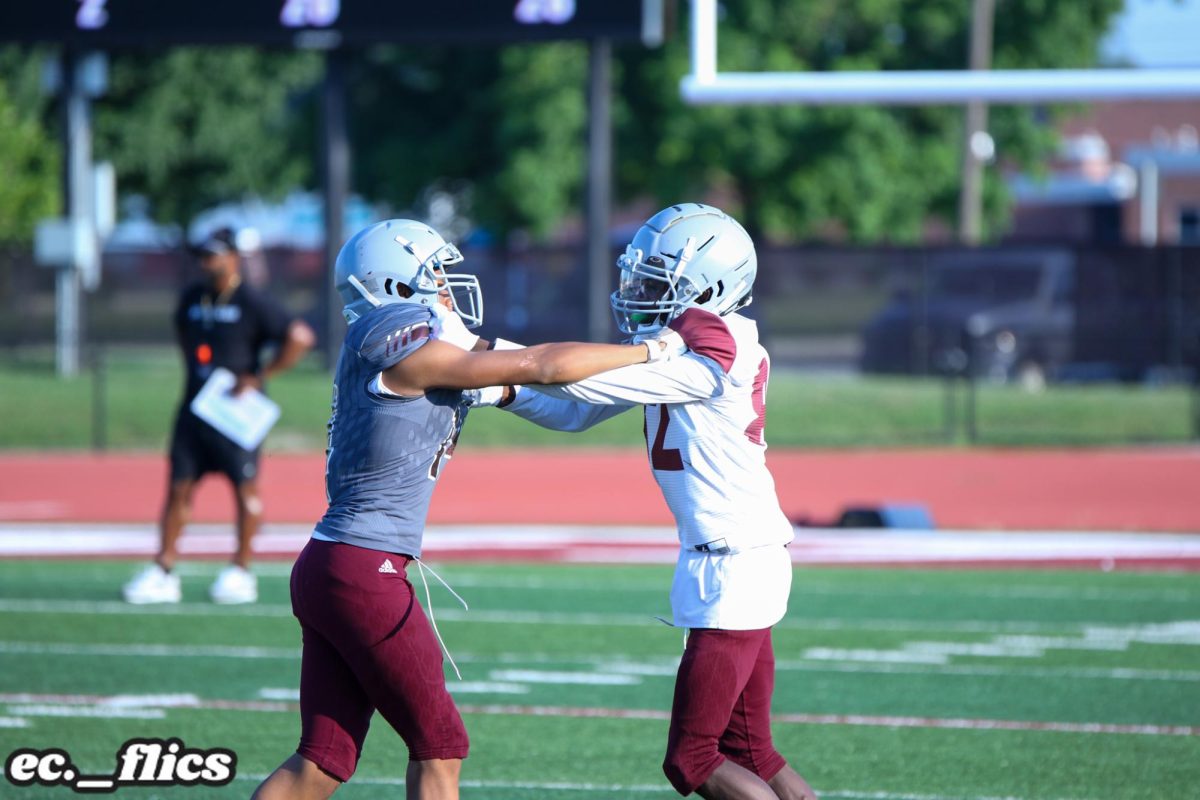 Daron Watson, White Jersey, blocks his opponent during the Maroon vs Gray Scrimmage.