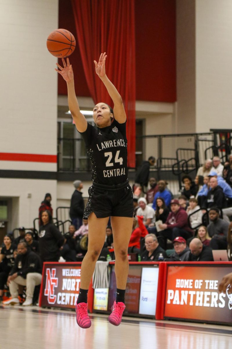 Aniyah Mckenzie, Senior, shoots a three pointer during the Sectional final game.
