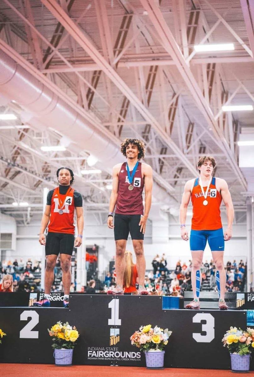 Evan Williams on the podium for Indoor State Track & Field 